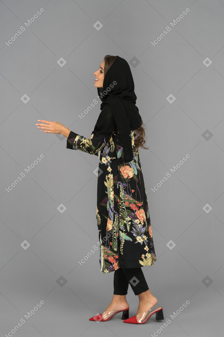 Cheerful turkish woman offering her hand for a handshake