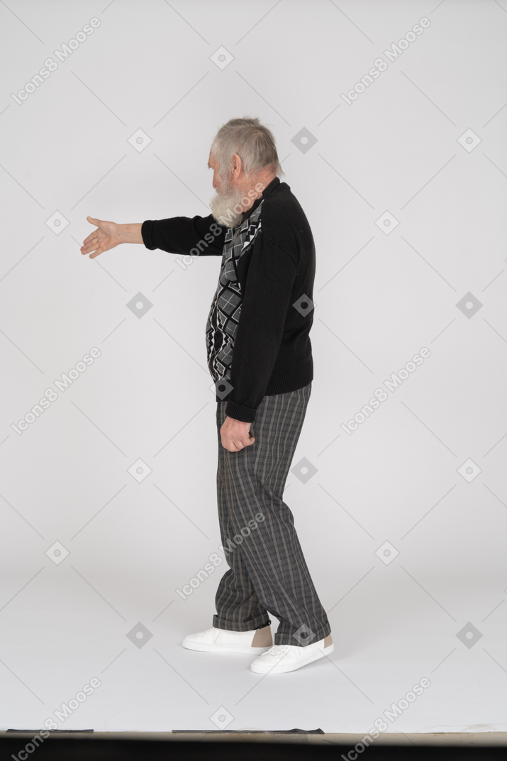 Side view of old man offering handshake