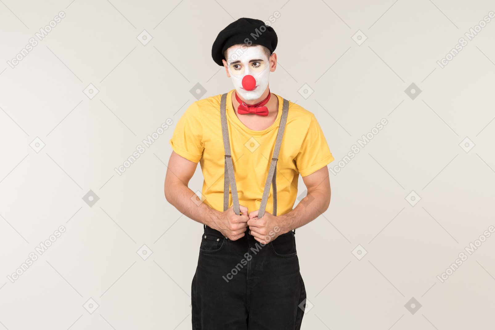 Offended looking male clown holding suspenders he's wearing