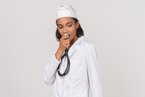 Attractive young female doctor holding a stethoscope