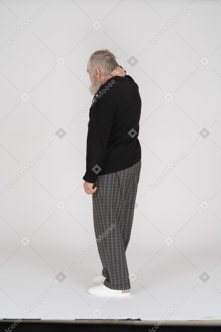 Rear view of old man with hand on neck