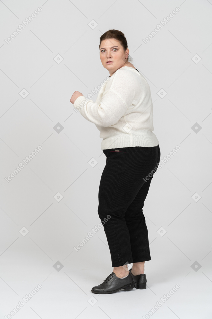 Scared plus size woman looking at camera