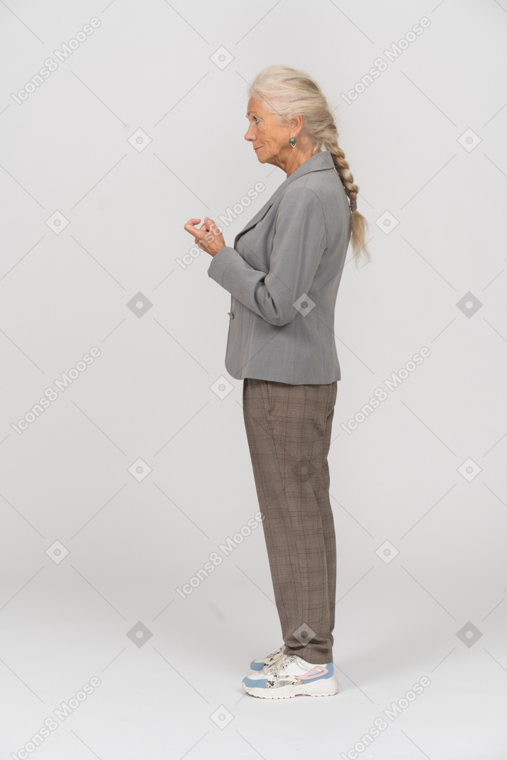 Side view of an old lady in suit asking to come closer