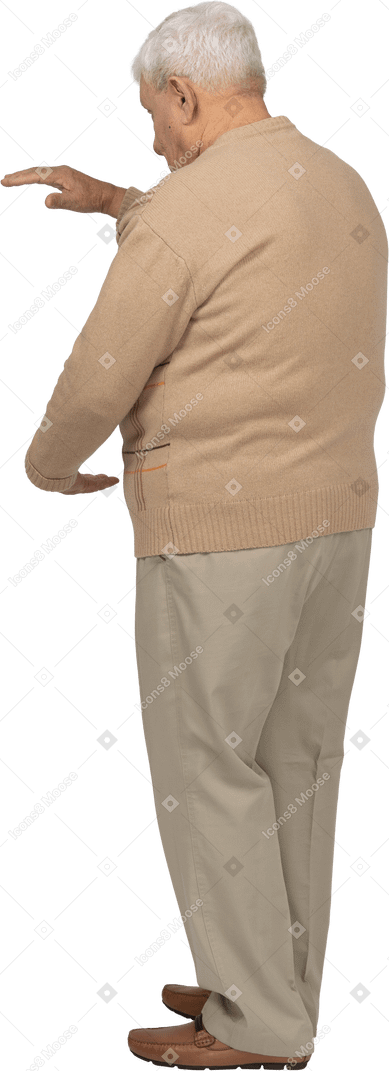 Side view of an old man in casual clothes showing size of something