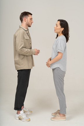 Side view of young couple speaking to each other