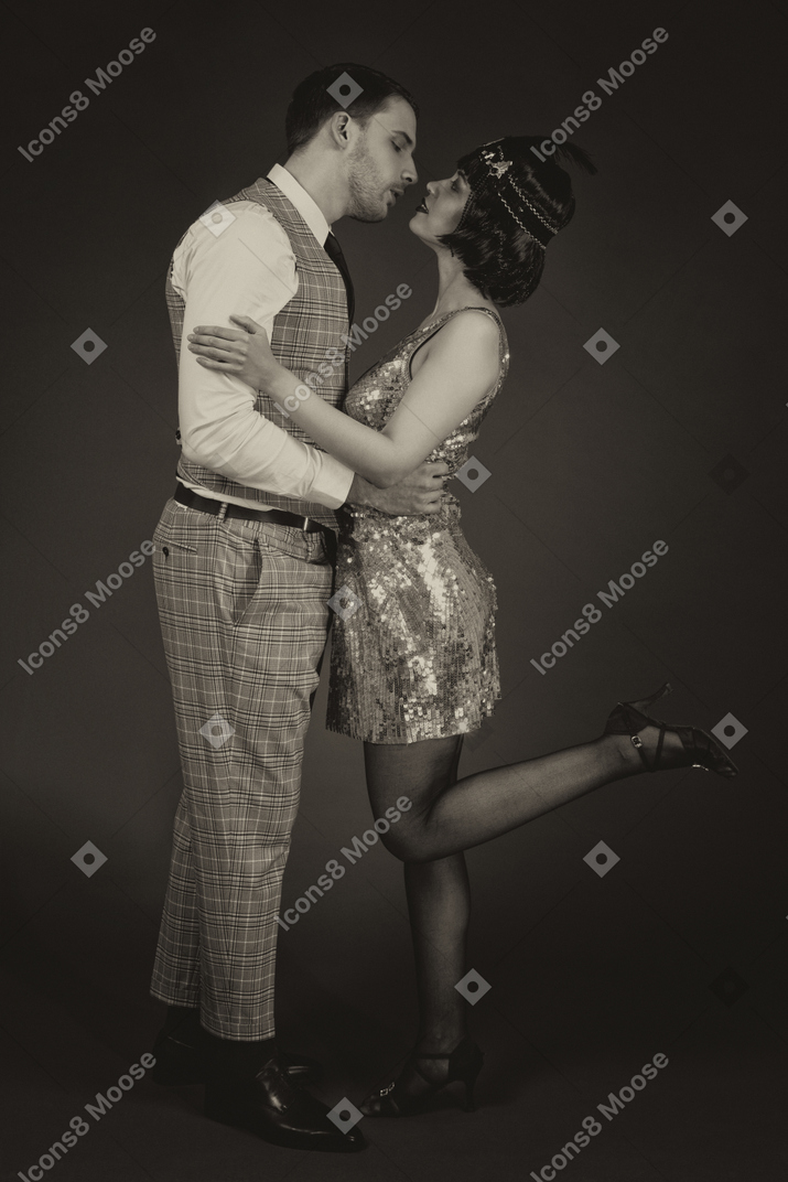 Retro-styled couple kissing in the dark