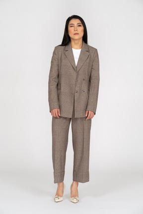 Front view of a winking young lady in brown business suit