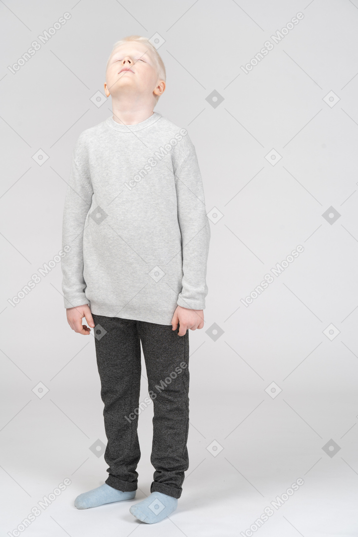 Front view of a tired kid boy in casual clothes