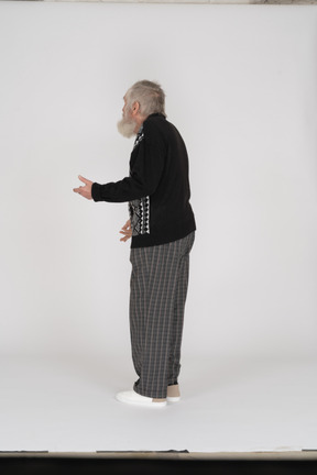 Three quarter back view of old man gesturing