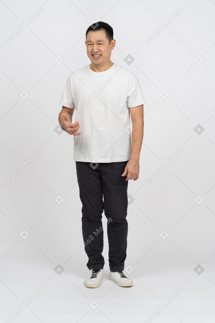 Front view of a man making funny face and doing phone gesture