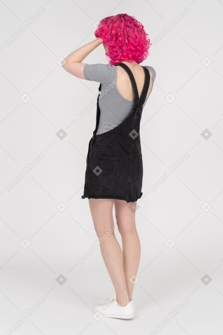 Full length portrait of an unrecognizable woman holding her head