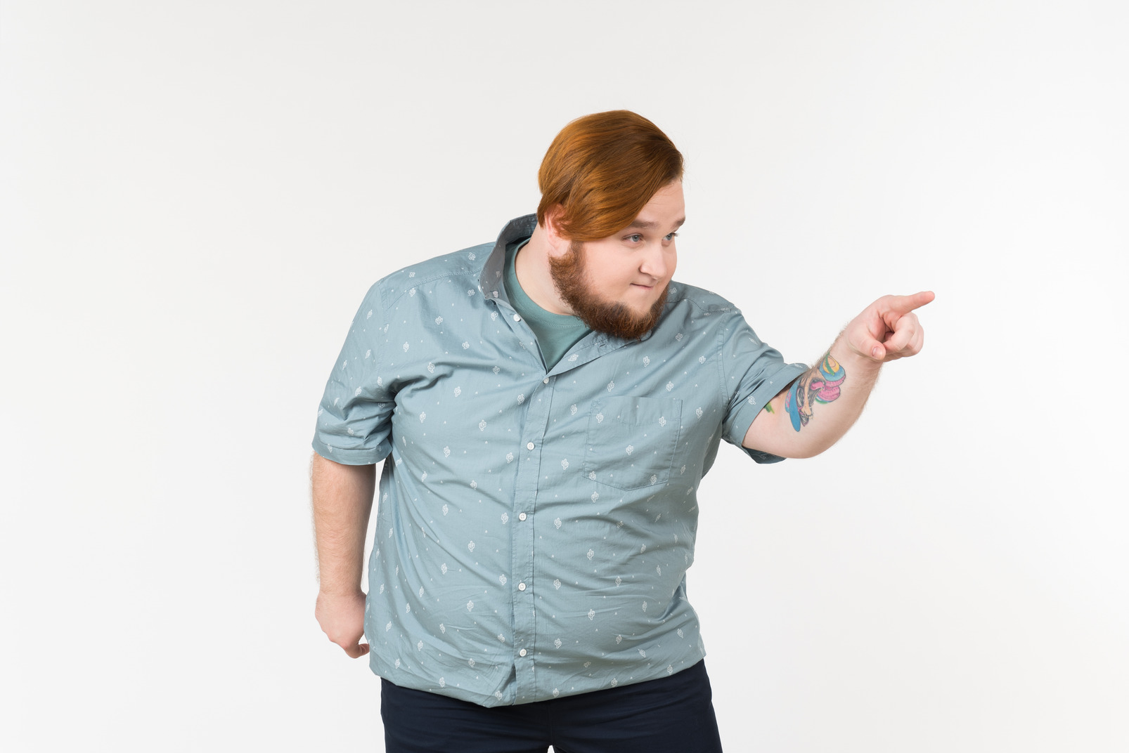 A fat man pointing at someone with a sly look