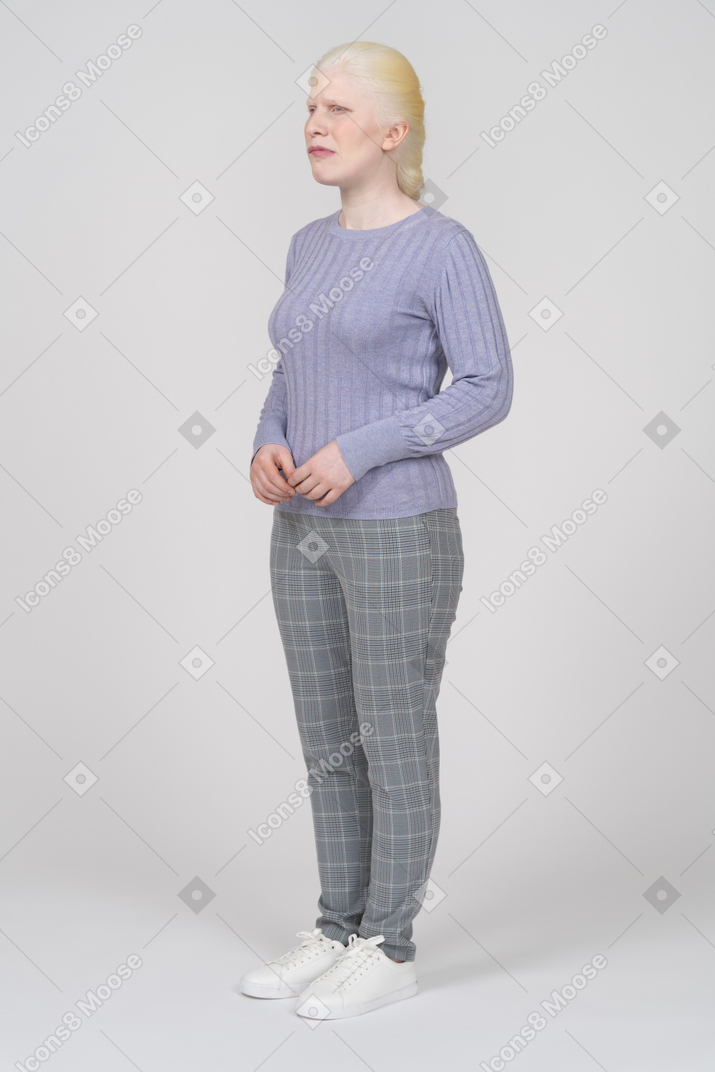 Upset woman in casual clothes standing still