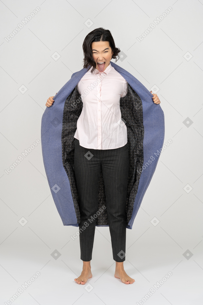 Excited woman holding coat wide open