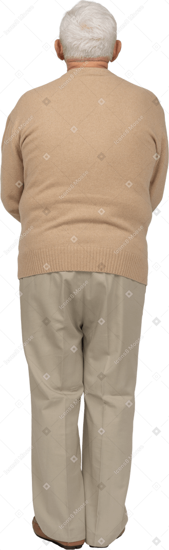 Rear view of an old man in casual clothes standing still