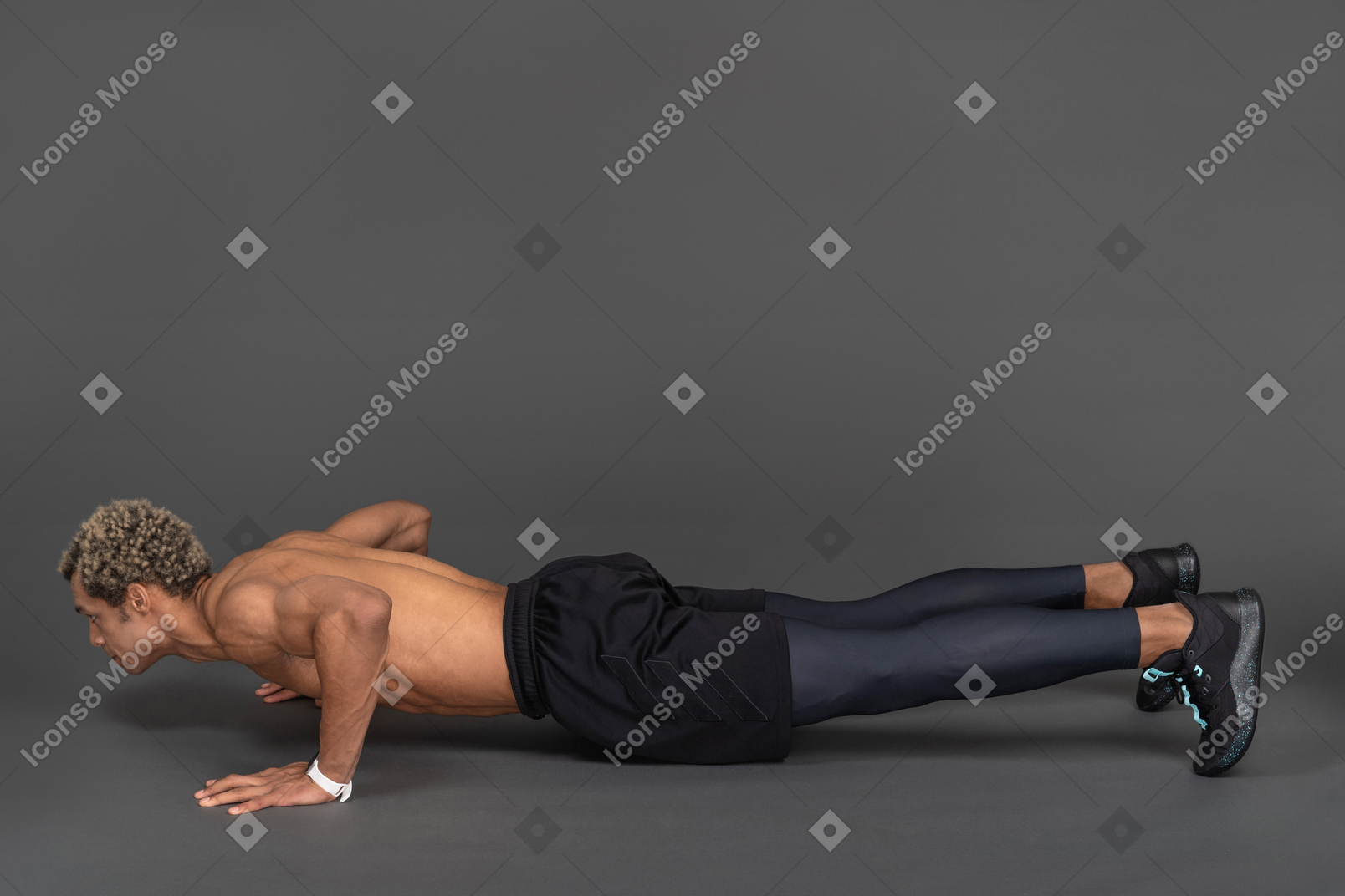 Side view of a shirtless afro man making push-ups