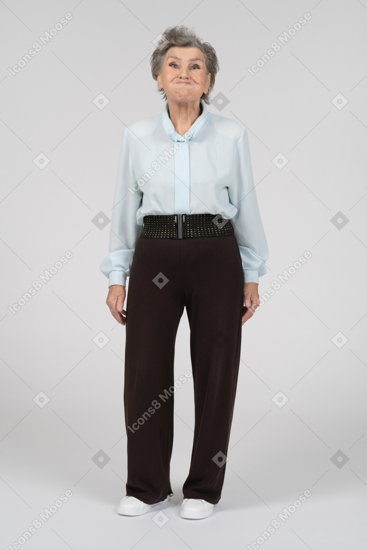 Vista frontale di una donna anziana che gonfia le guance