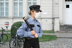 A woman police officer standing in front of a building