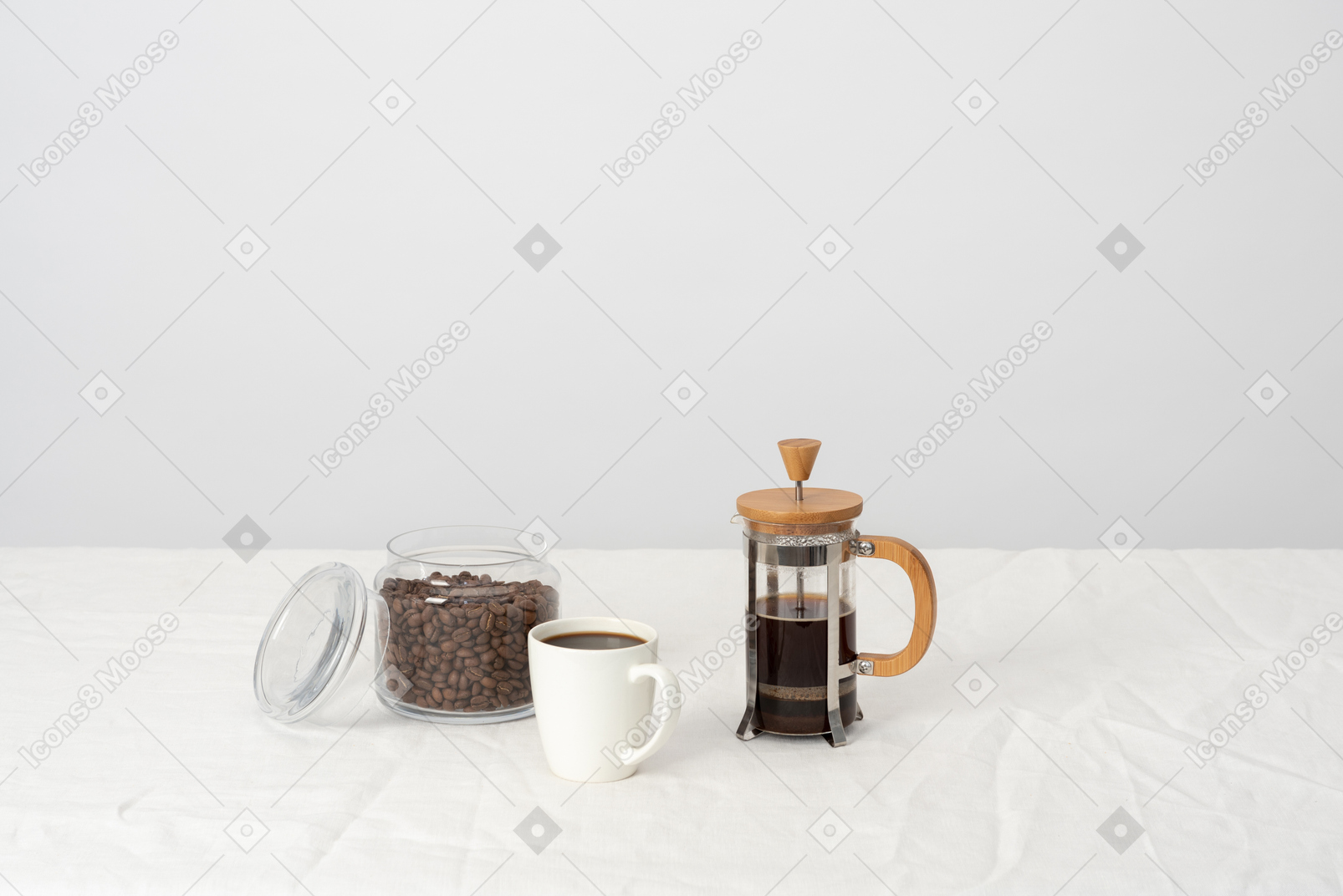 Coffee in french press, large cup of black coffee and jar with coffee beans