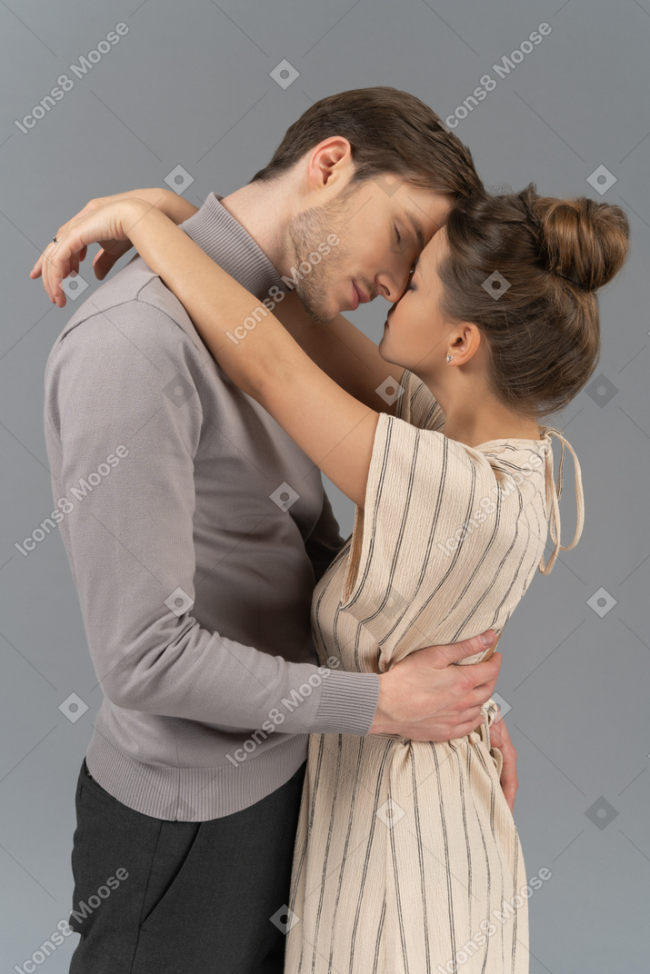 Side view of a young couple hugging