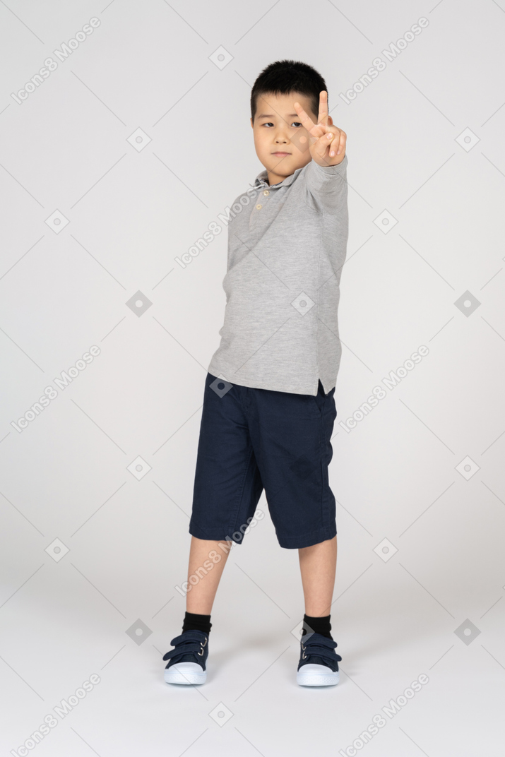 Boy showing peace gesture