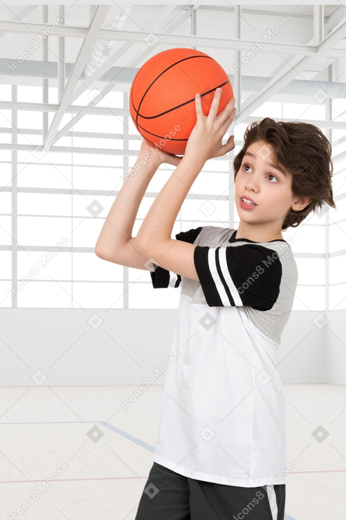 Side profile of a boy playing basketball