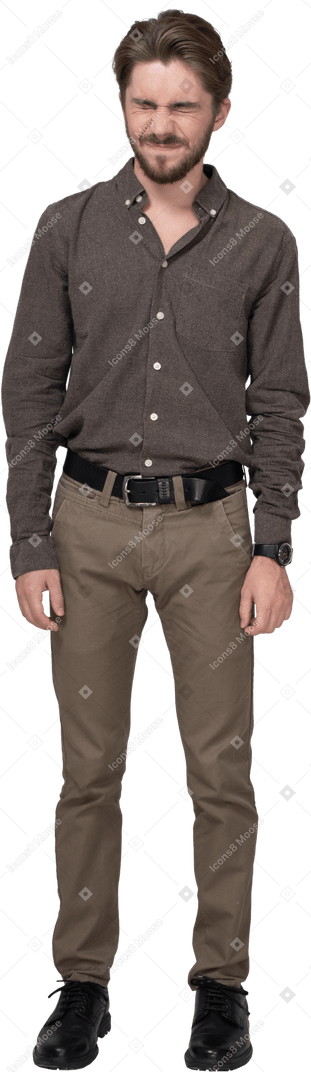 Front view of a grimacing displeased young man in office clothing