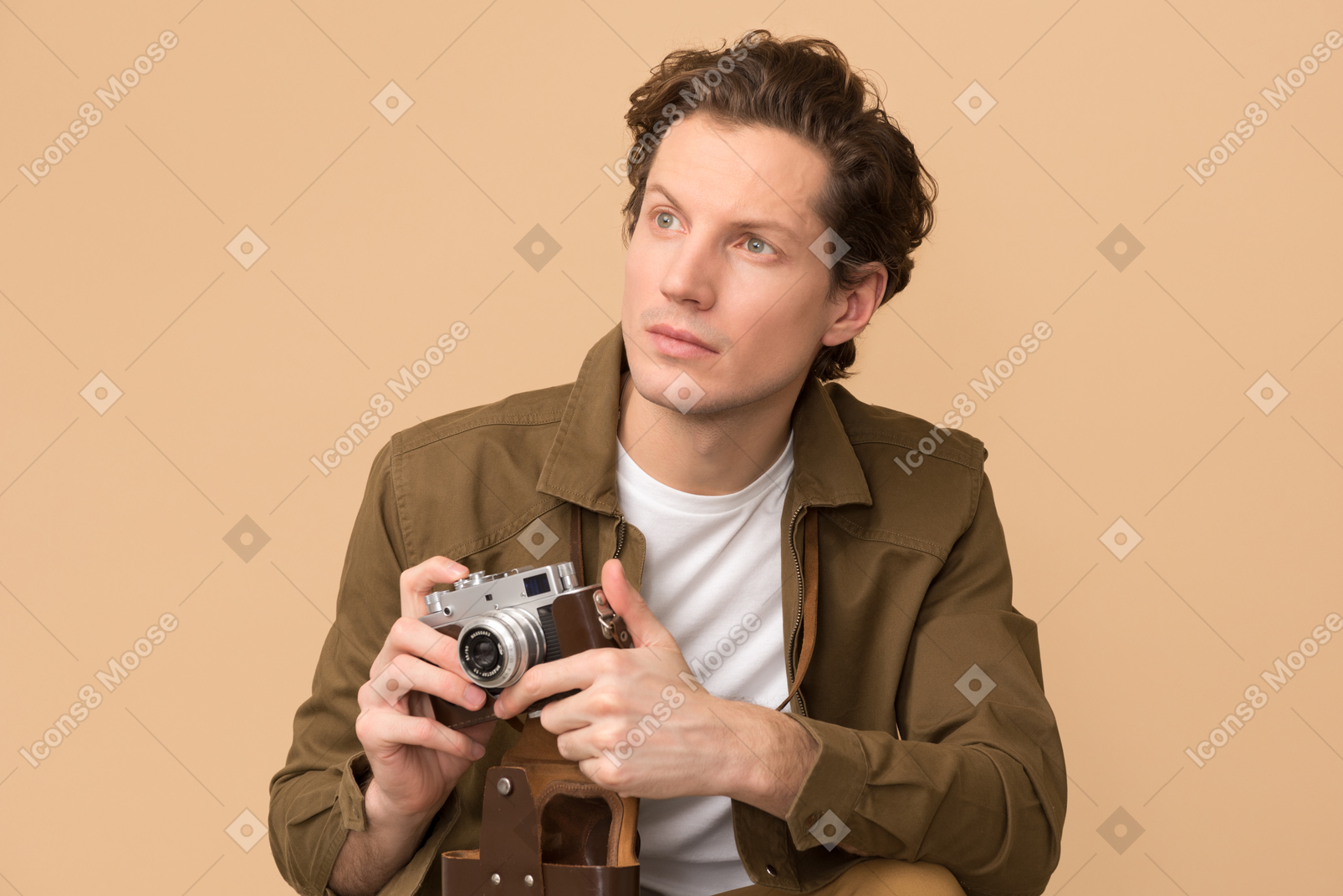 Handsome young man holding a camera