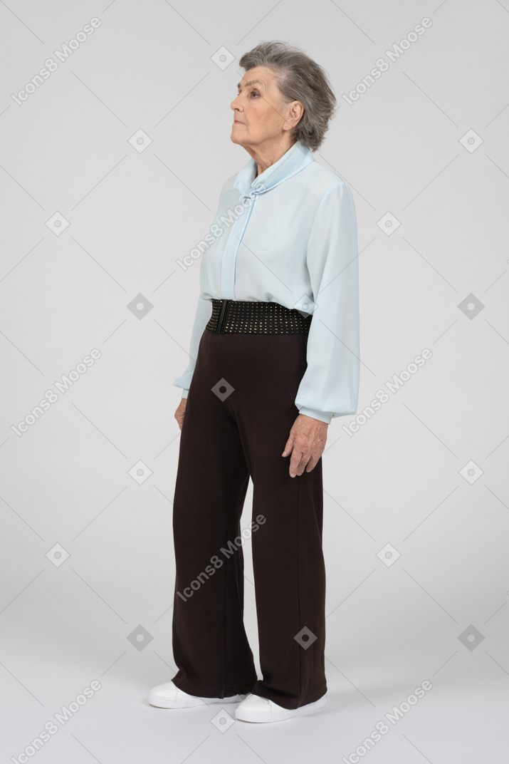 Old woman standing and looking straight