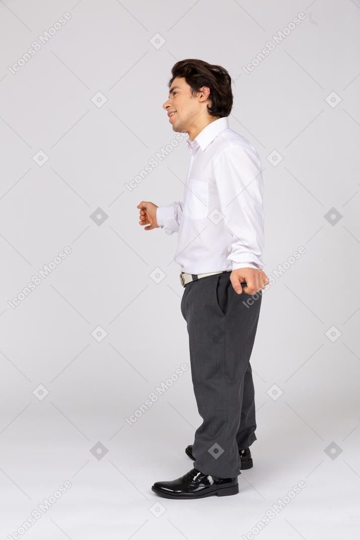 Side view of a cheerful office worker dancing