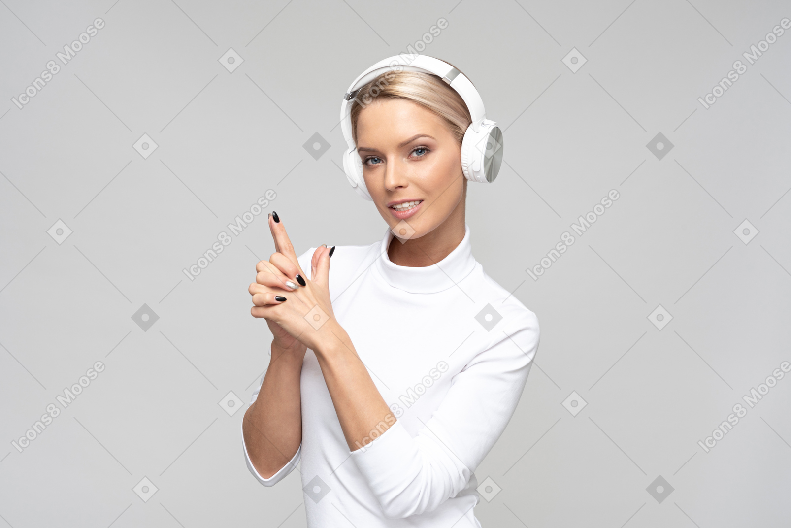 Young beautiful woman listening to music in headphones