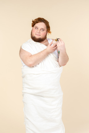 Big guy wrapped in towel applying perfume