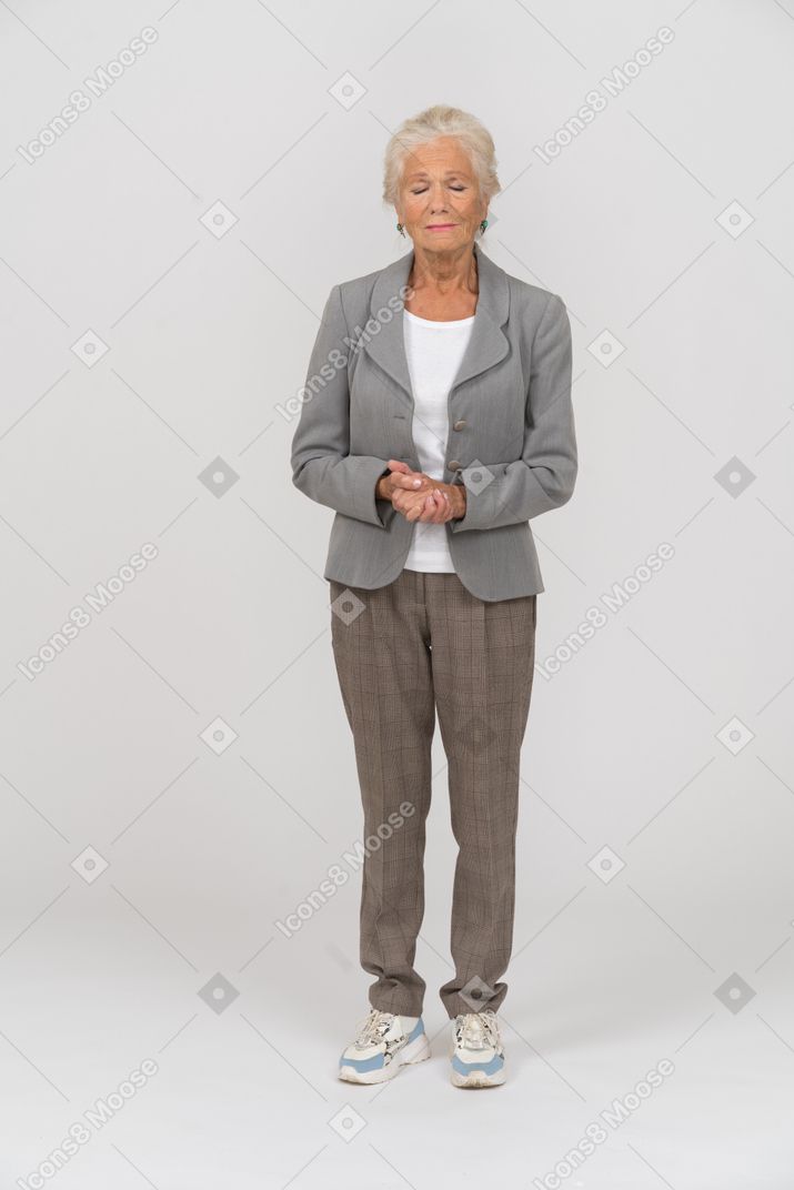 Front view of an old woman in suit