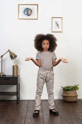 Good looking girl kid posing on the apartment background