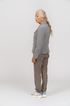 Rear view of an old lady in grey jacket