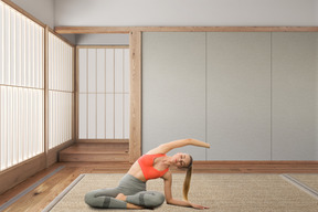 A woman doing a yoga pose in front of a room