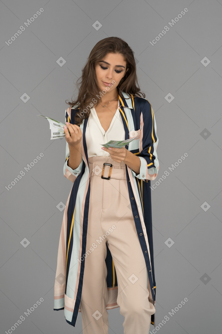 Serious middle-eastern woman counting money