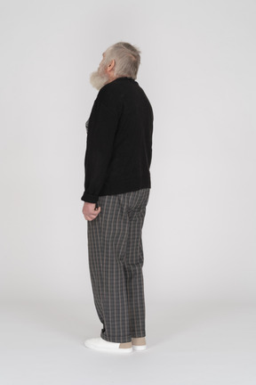 Three quarter back view of an old man with head up