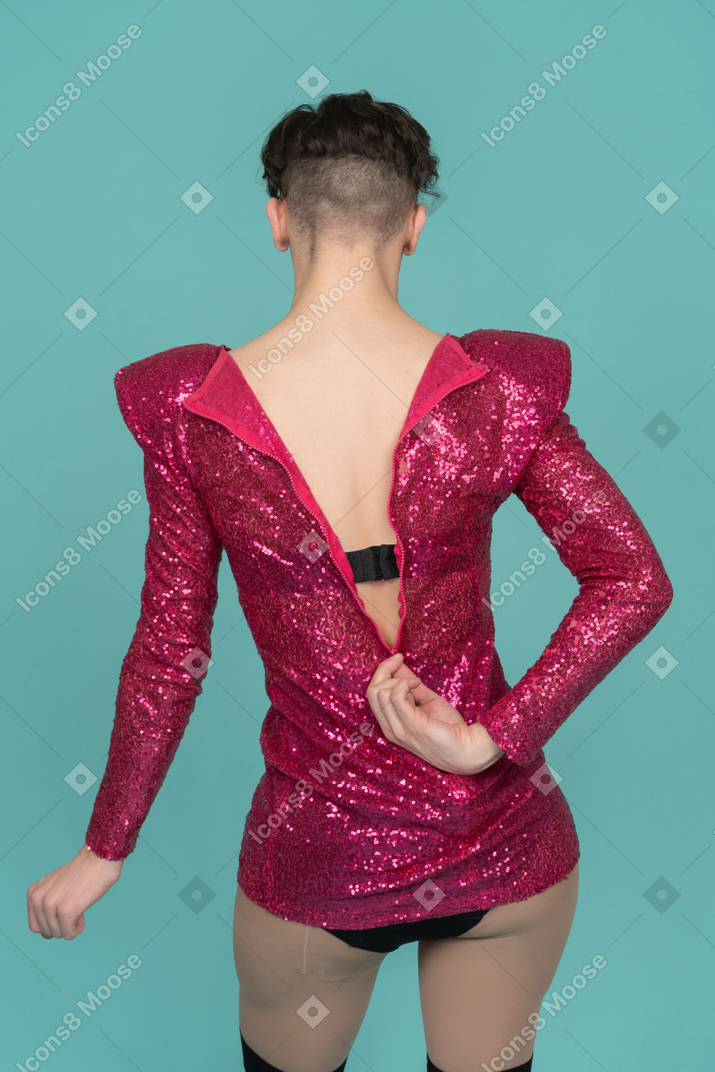 Back view of a drag queen unzipping pink dress