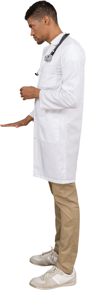 Side view of a young doctor showing a size of something