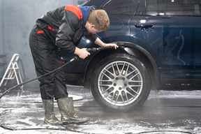 Young man washing car