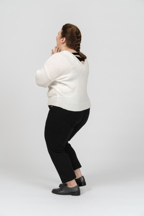 Surprised plump woman in white sweater