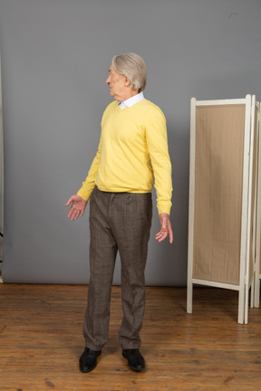 Front view of a questioning old man turning around