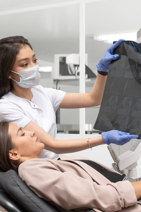 Doctor showing x-ray to patient