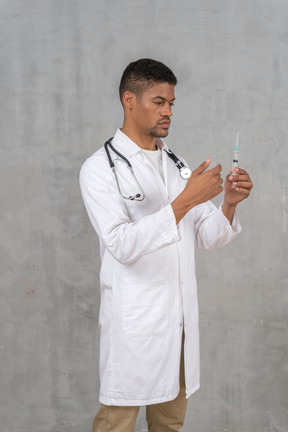 Male doctor preparing a syringe