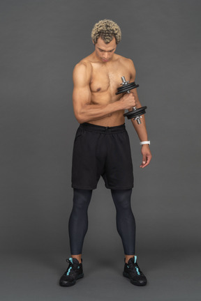 Athletic man working out with a dumbbell