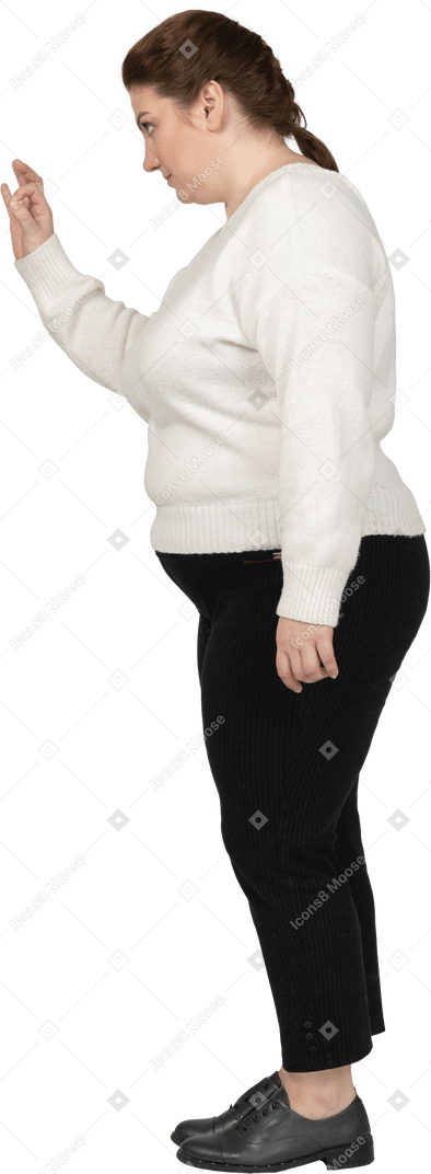 Plus size woman in white sweater showing ok sign