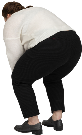 Rear view of a plump woman in casual clothes bending down