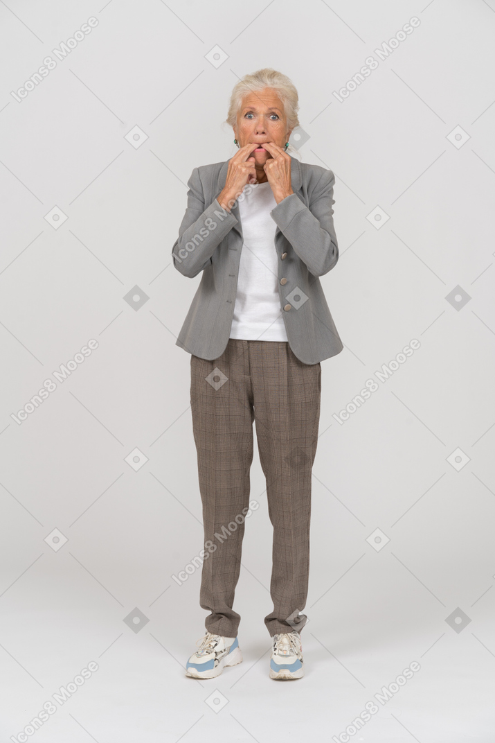 Front view of an old lady in suit whistling