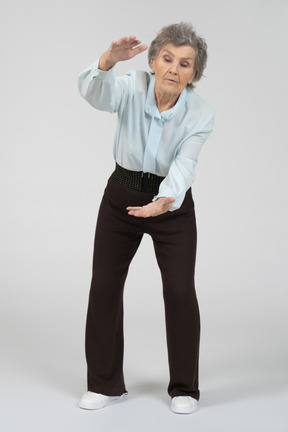 Old woman showing the size with both hands